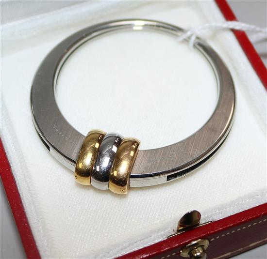 A Must de Cartier steel and yellow metal circular money clip, numbered 001696, 48mm.